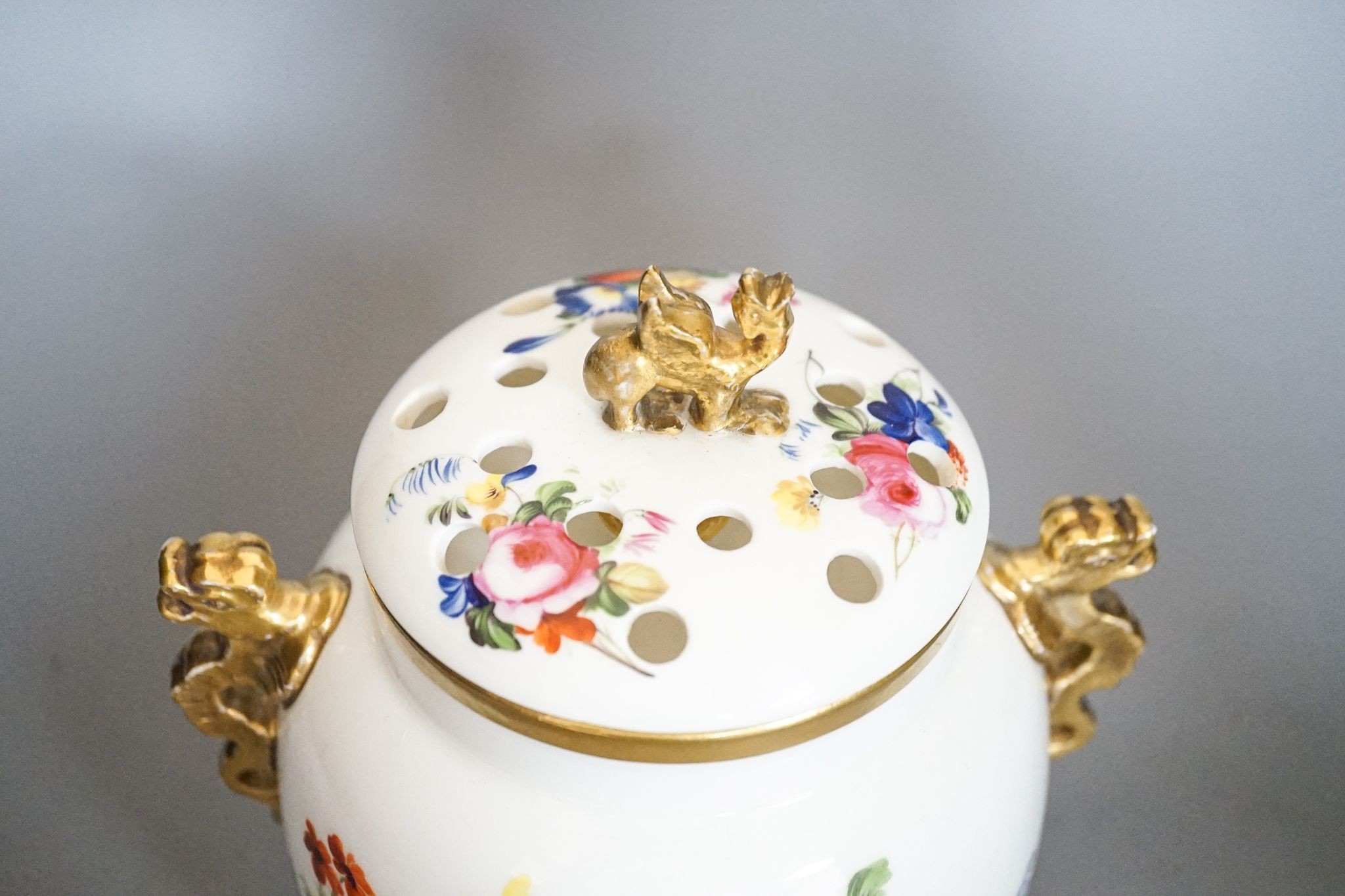 An English porcelain pot pourri vase, cover and inner cover, probably Coalport, painted with roses and flowers 21cm